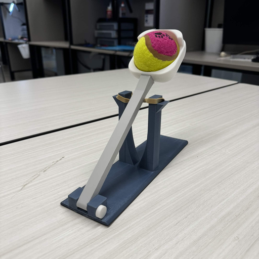 Rubber-band powered ball launcher prototype holding a ball