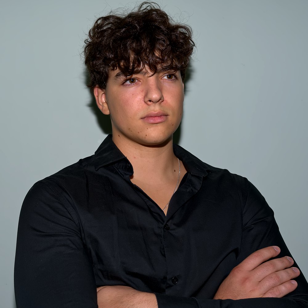 Eugene Koblytskyy in a black shirt, arms crossed