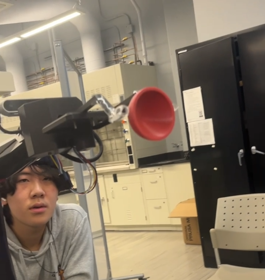 Live test of the second claw design gripping a red bowl