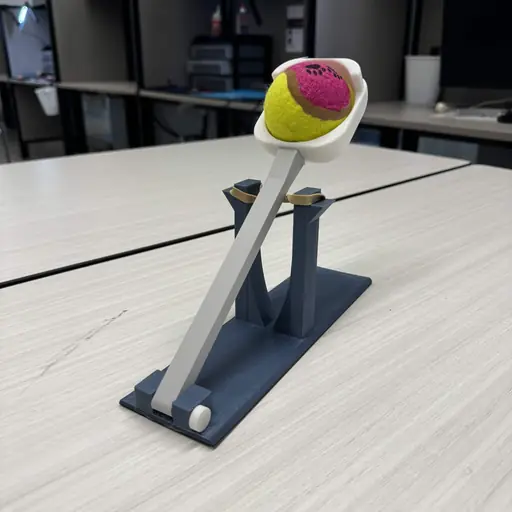 Rubber-band ball launcher prototype holding a ball